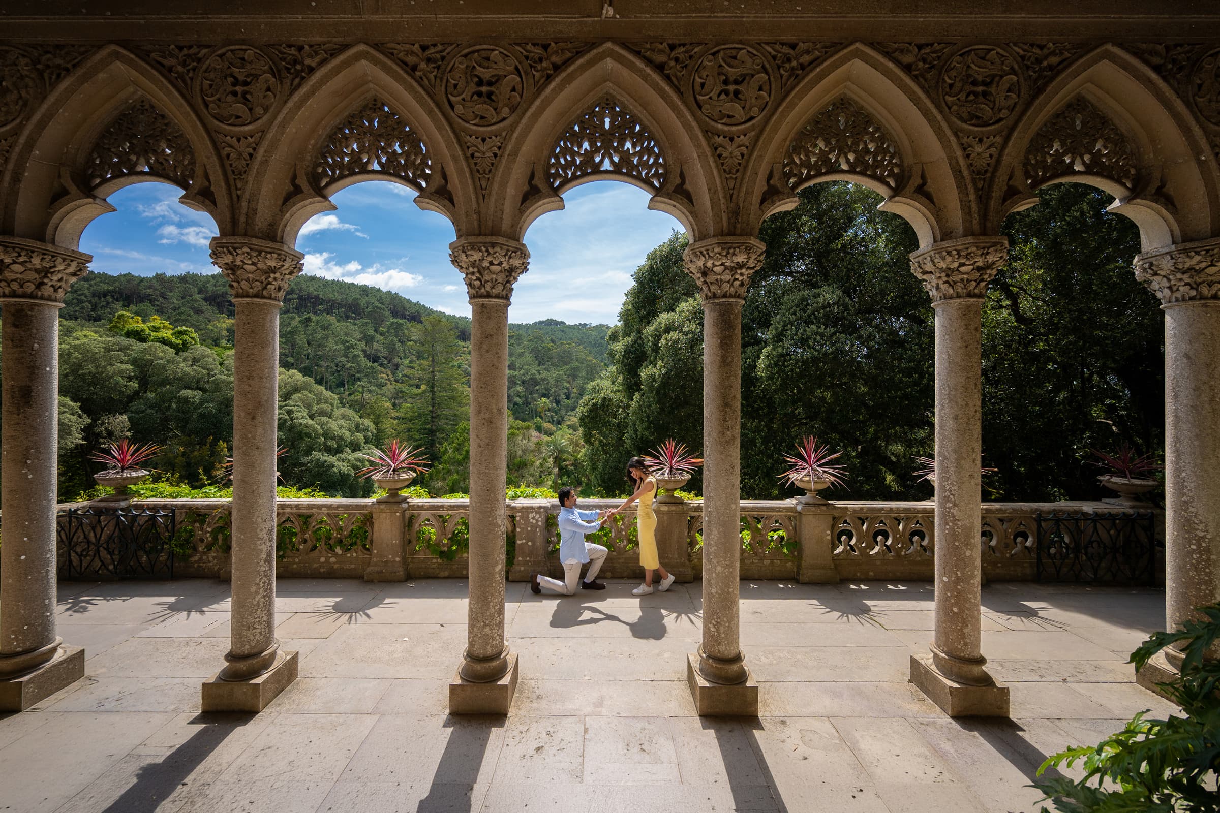 Marriage proposal at Monserrate Palace in Sintra, photographed from afar through the gallery arches