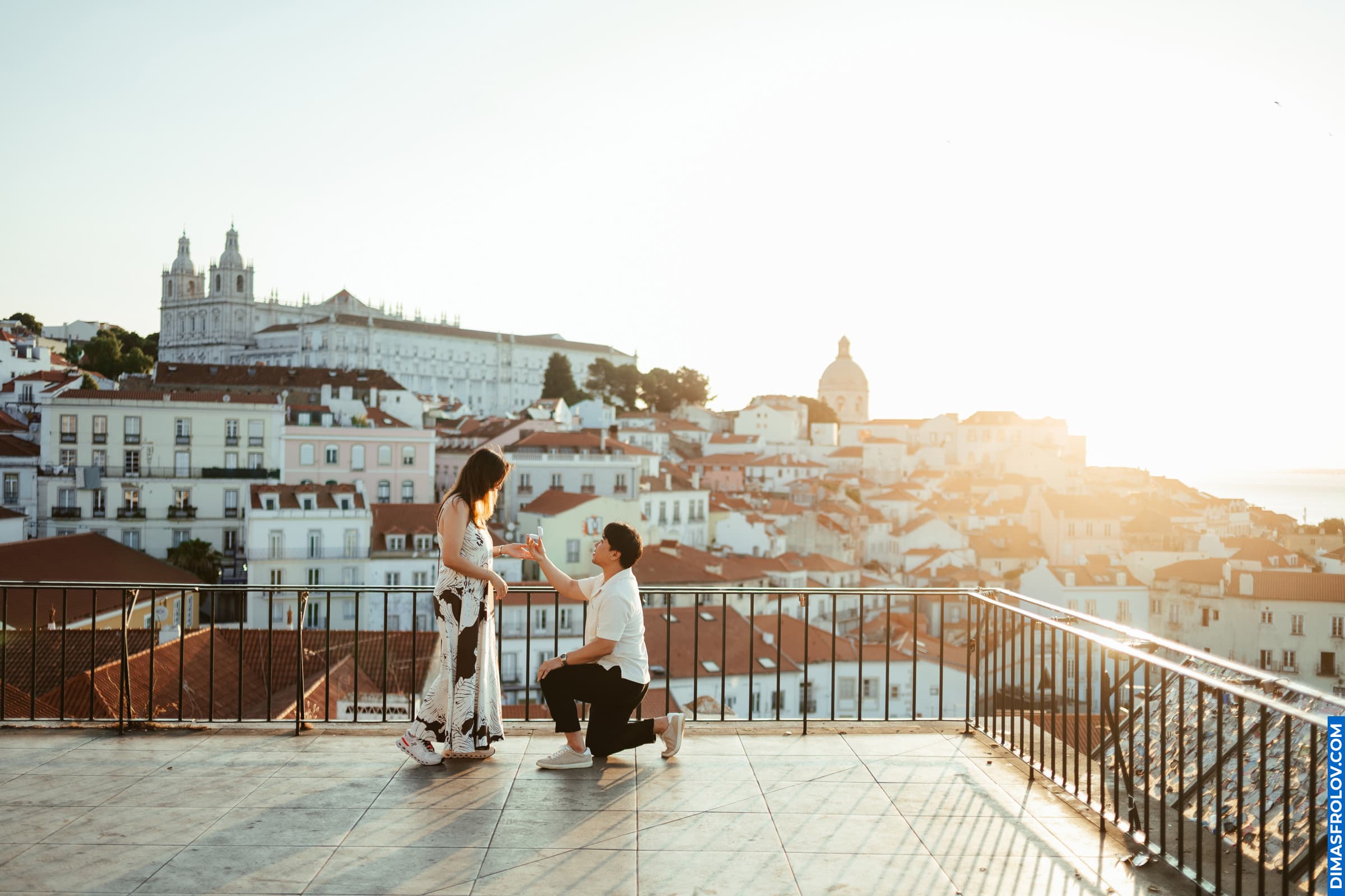 Surprise marriage proposal at Miradouro das Portas do Sol in Lisbon, man on one knee in front of his girlfriend