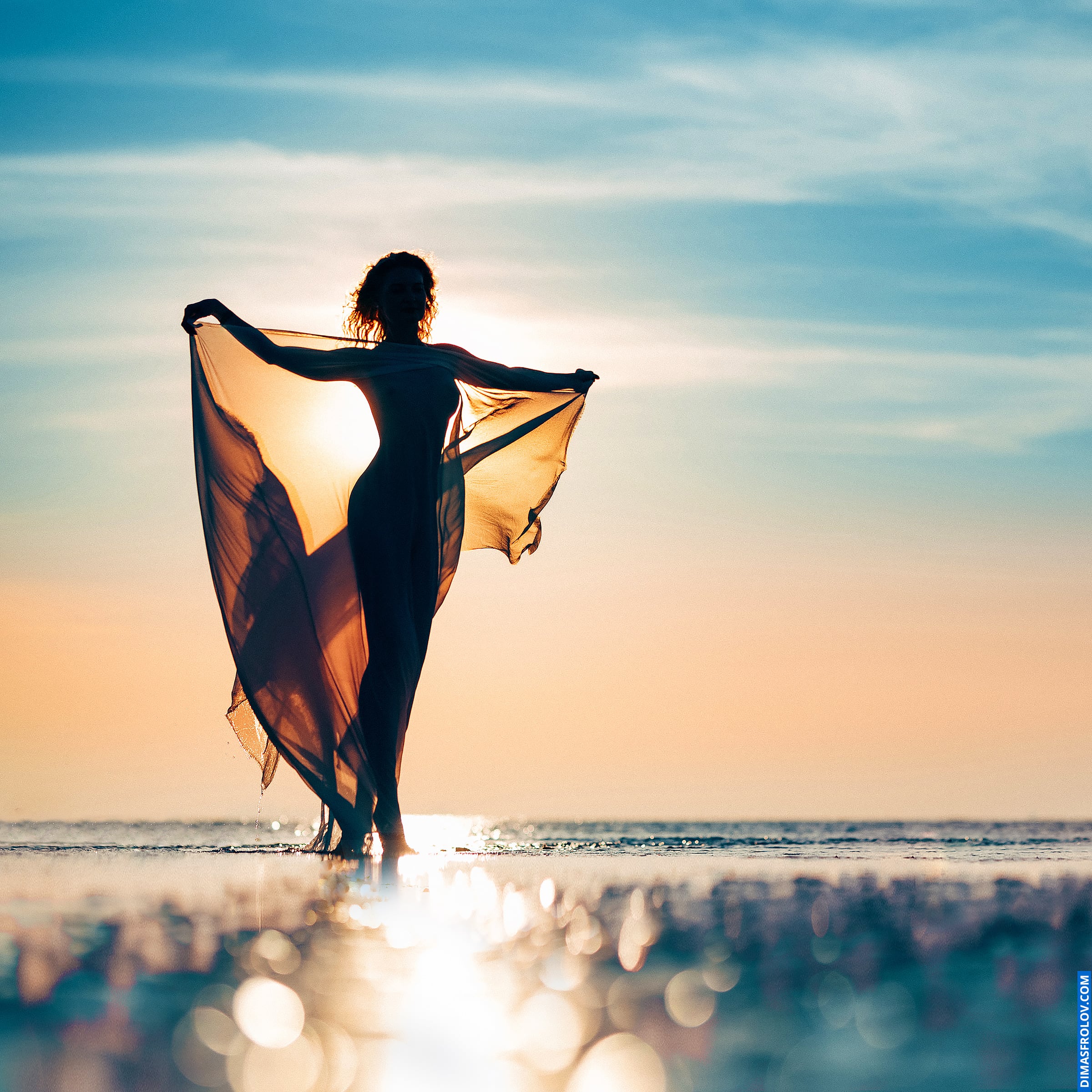 Woman’s silhouette at sunset during a fashion photo shoot